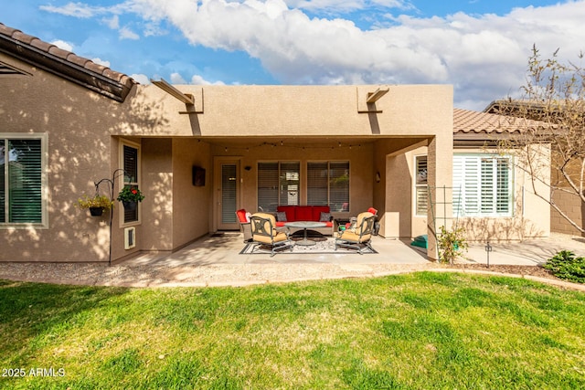 rear view of house with a yard, an outdoor hangout area, and a patio area