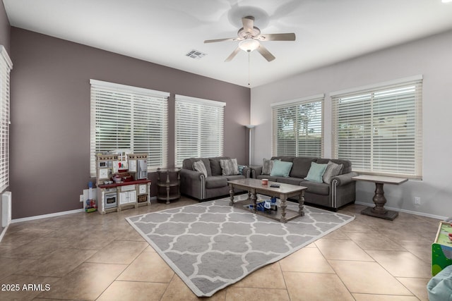 tiled living room featuring ceiling fan