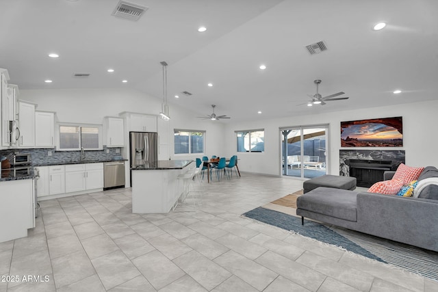 6201 E Waltann Ln, Scottsdale, AZ 85254 - kitchen with open floor plan, appliances with stainless steel finishes, a kitchen island, a ceiling fan, and recessed lighting