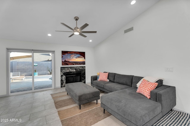 6201 E Waltann Ln, Scottsdale, AZ 85254 - living area with vaulted ceiling, ceiling fan, recessed lighting, and a premium fireplace