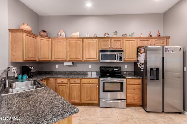 5271 E 10th Ave, Apache Junction, AZ 85119 - kitchen with stainless steel appliances, light tile patterned floors, recessed lighting, and dark stone counters