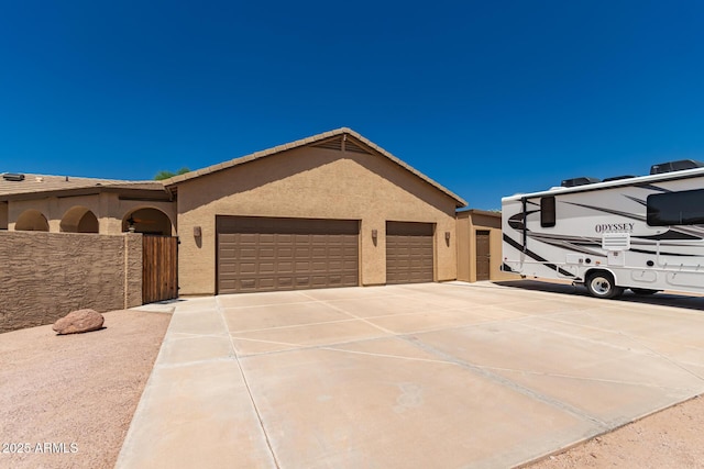 5271 E 10th Ave, Apache Junction, AZ 85119 - view of front of home featuring driveway, a garage, and stucco siding