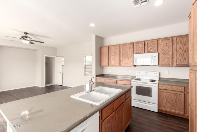 kitchen featuring visible vents, dark wood-type flooring, a sink, ceiling fan, and white appliances