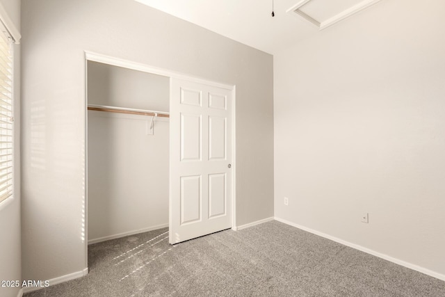 unfurnished bedroom featuring carpet, a closet, and baseboards