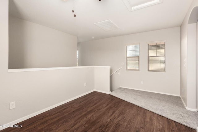 spare room with dark wood-style floors and baseboards