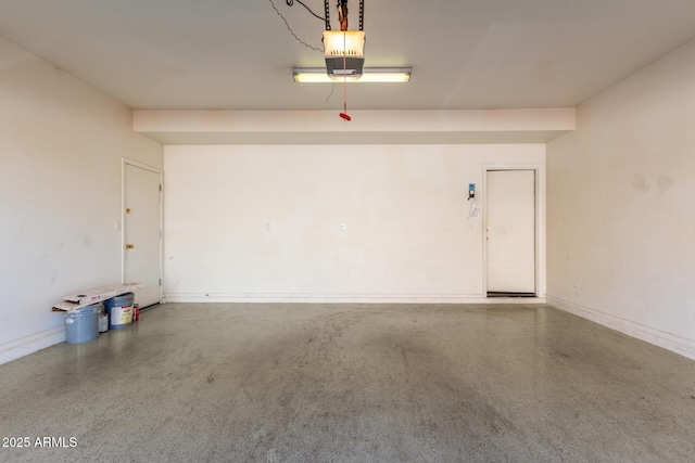 garage featuring baseboards and a garage door opener