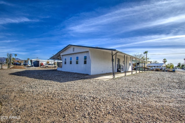 view of side of home with a patio