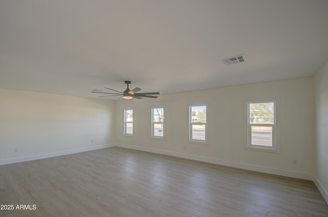 spare room featuring light hardwood / wood-style floors and ceiling fan