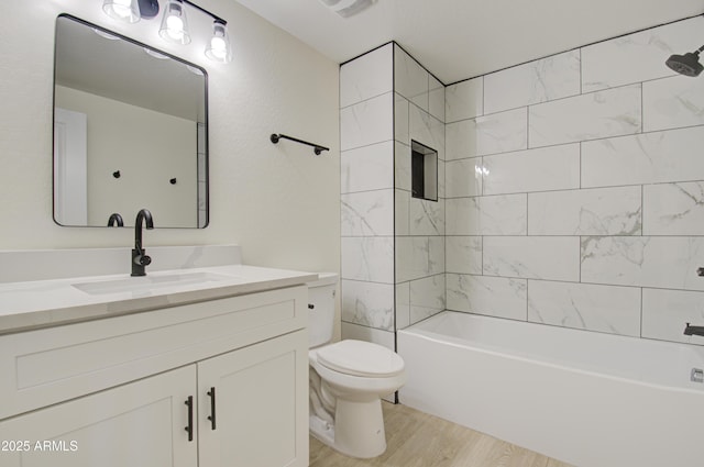 full bathroom with vanity, toilet, tiled shower / bath, and wood-type flooring