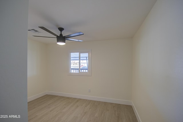 spare room with light hardwood / wood-style flooring and ceiling fan