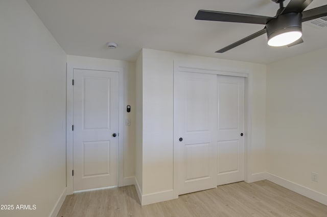 unfurnished bedroom with ceiling fan, light hardwood / wood-style floors, and a closet