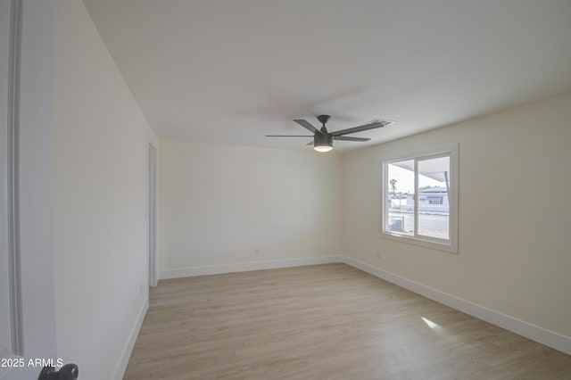 spare room featuring ceiling fan and light hardwood / wood-style floors