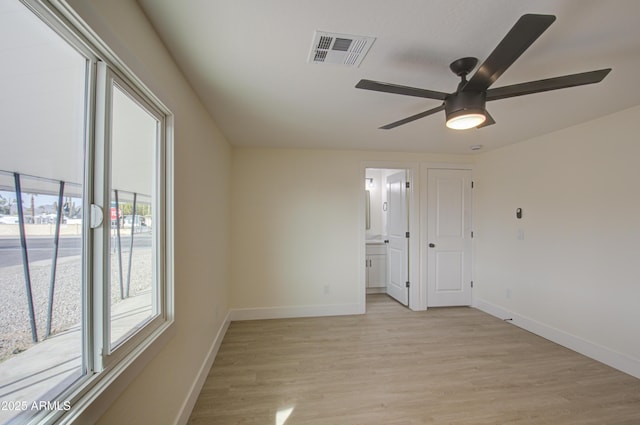 empty room featuring ceiling fan and light hardwood / wood-style flooring