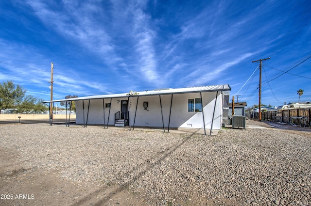 rear view of property featuring cooling unit