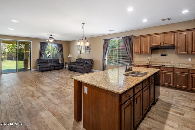 2614 E Carob Dr, Gilbert, AZ 85298 - kitchen with under cabinet range hood, black appliances, recessed lighting, light wood-style flooring, and an island with sink