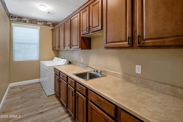 2614 E Carob Dr, Gilbert, AZ 85298 - washroom featuring cabinet space, separate washer and dryer, and light wood-style floors