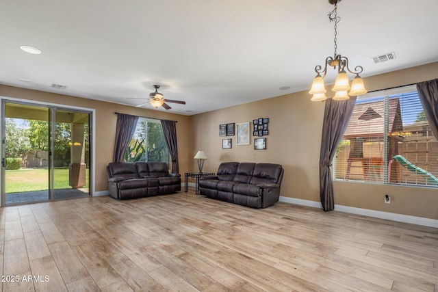 2614 E Carob Dr, Gilbert, AZ 85298 - living area with light wood-type flooring, a chandelier, and a ceiling fan