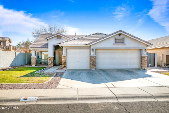 view of front of home with a front yard and a garage