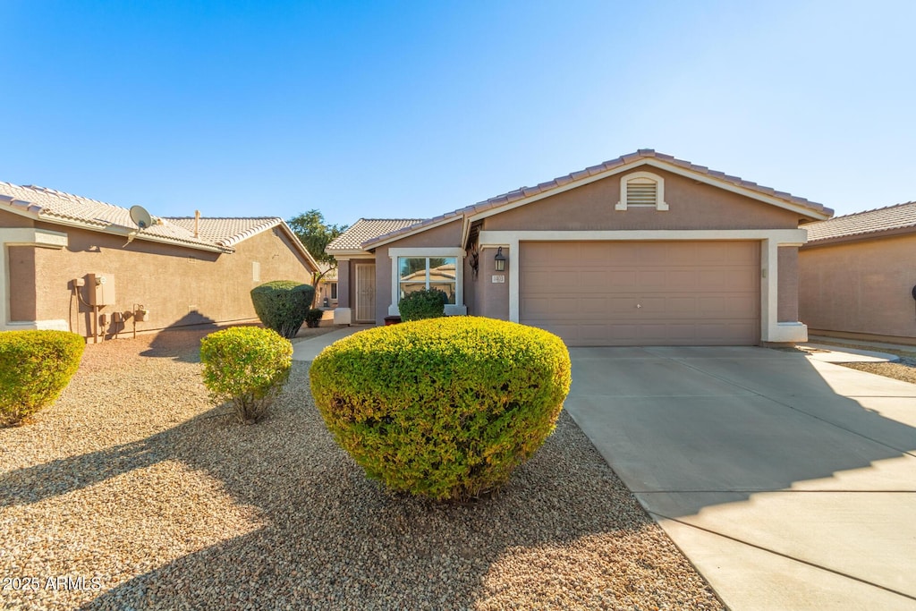 ranch-style home featuring a garage