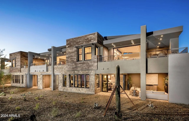 rear view of house featuring a balcony