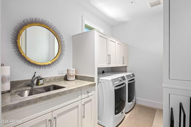 laundry room featuring light tile flooring, cabinets, independent washer and dryer, and sink