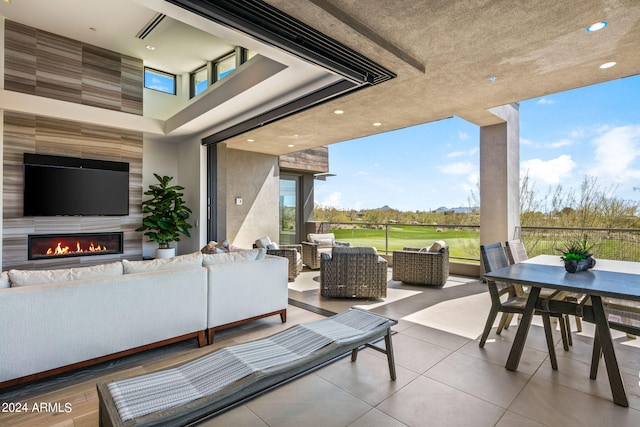 view of patio featuring an outdoor living space with a fireplace