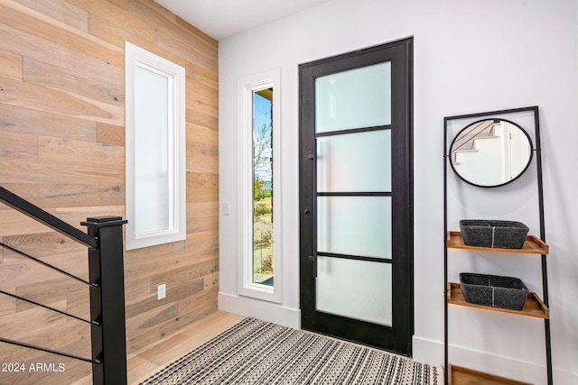 doorway to outside featuring wooden walls