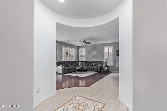 living area featuring light tile patterned flooring and a ceiling fan