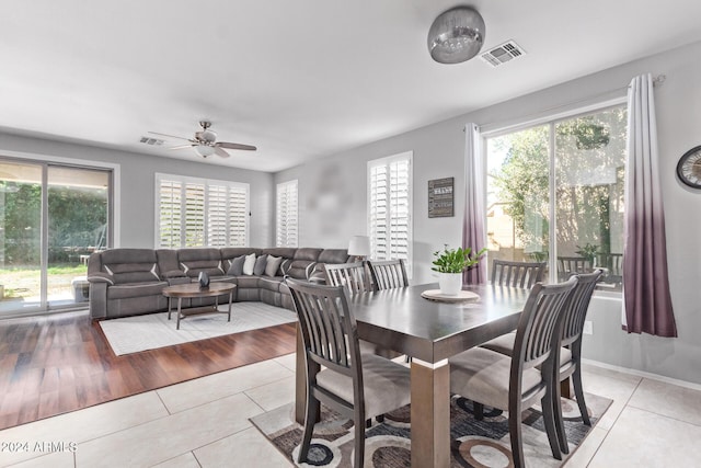 dining room featuring light tile patterned floors, visible vents, and a ceiling fan