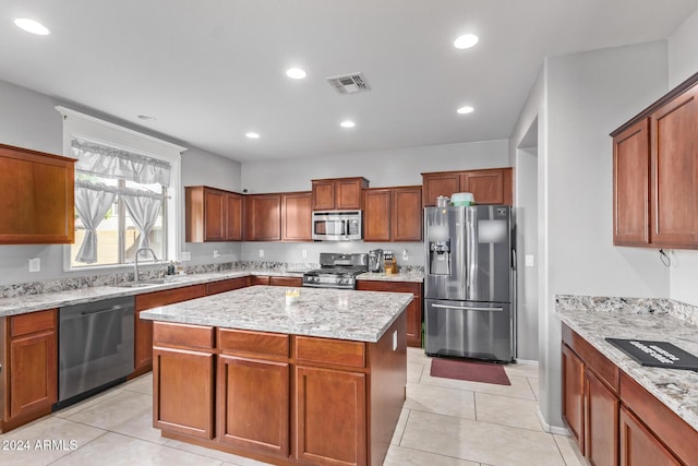 kitchen featuring visible vents, a kitchen island, recessed lighting, a sink, and appliances with stainless steel finishes