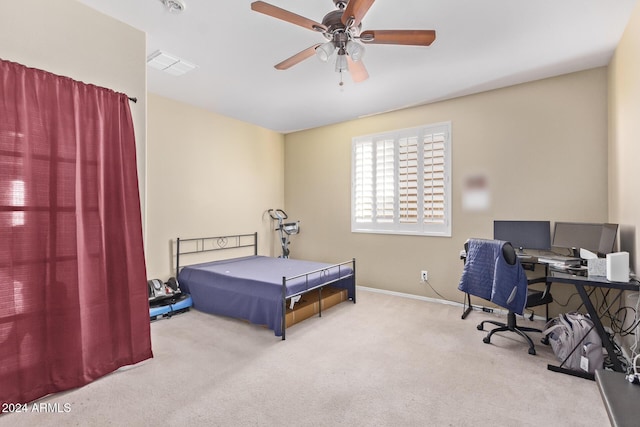 carpeted bedroom featuring a ceiling fan, visible vents, and baseboards