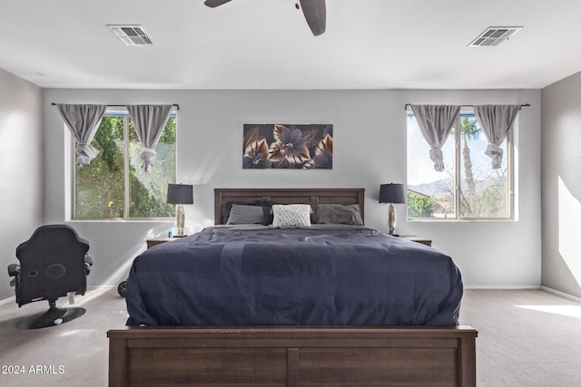 bedroom featuring multiple windows, carpet flooring, and visible vents