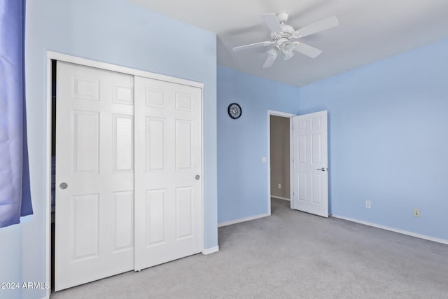 unfurnished bedroom featuring ceiling fan, carpet, a closet, and baseboards