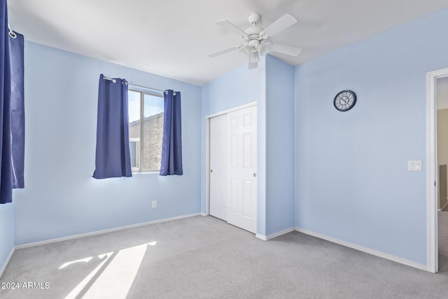 unfurnished bedroom with a ceiling fan, carpet flooring, baseboards, and a closet