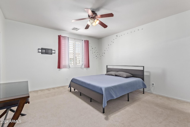 carpeted bedroom with visible vents, baseboards, and ceiling fan