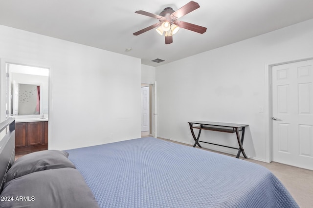 carpeted bedroom featuring visible vents, ensuite bath, and ceiling fan