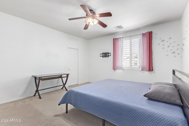 carpeted bedroom with visible vents and ceiling fan