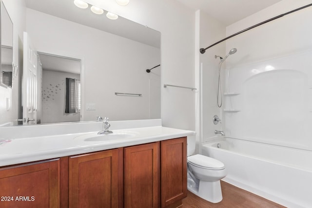 full bathroom with toilet, vanity,  shower combination, and wood finished floors