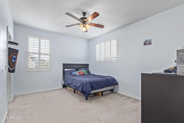 carpeted bedroom with baseboards and ceiling fan