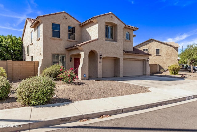 mediterranean / spanish home featuring stucco siding and a tiled roof