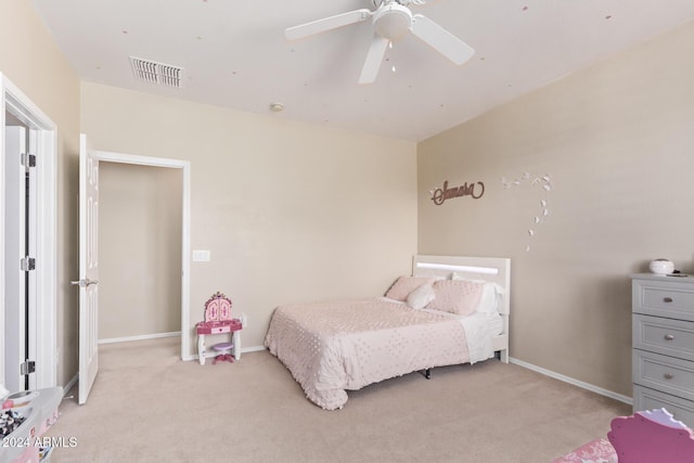 bedroom featuring a ceiling fan, light colored carpet, visible vents, and baseboards