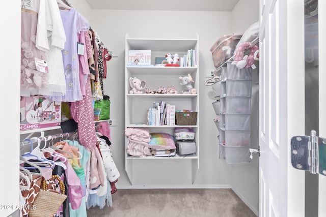 walk in closet with carpet flooring