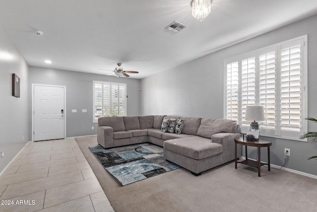 tiled living area featuring visible vents, baseboards, and a ceiling fan