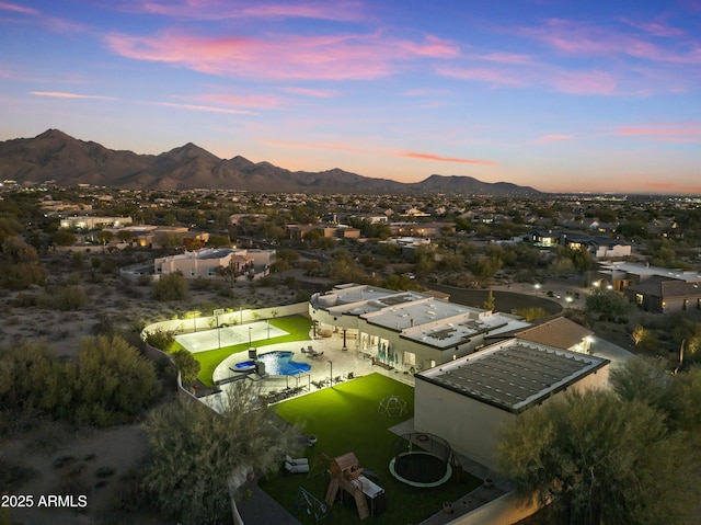 aerial view at dusk featuring a mountain view