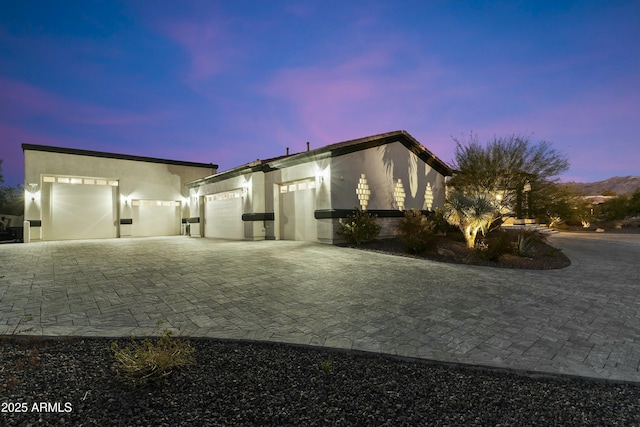 property exterior at dusk featuring a garage