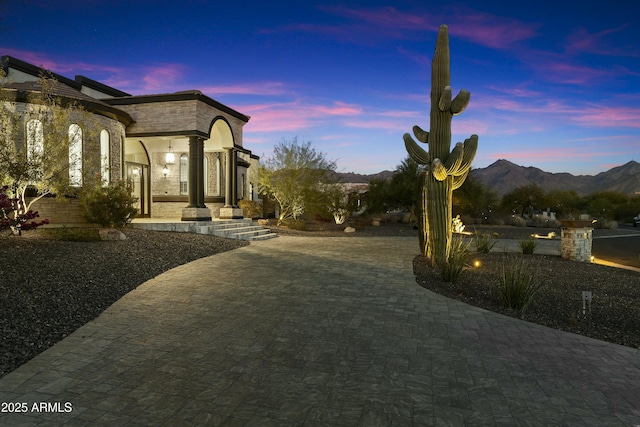 yard at dusk featuring a mountain view