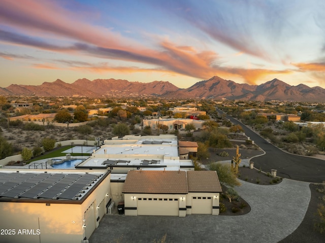 aerial view at dusk featuring a mountain view