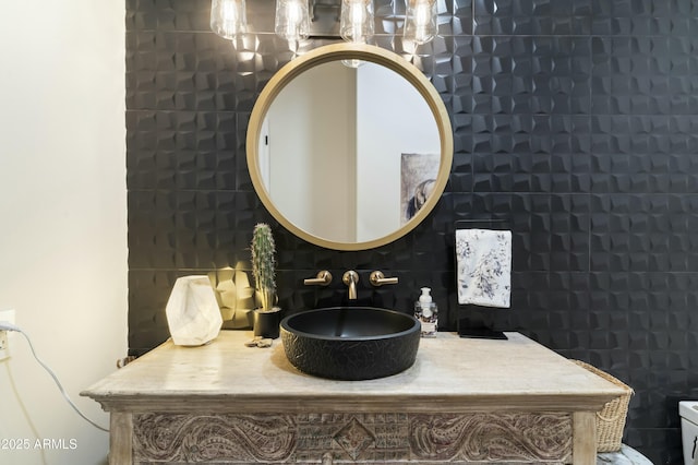 bathroom featuring tasteful backsplash and sink