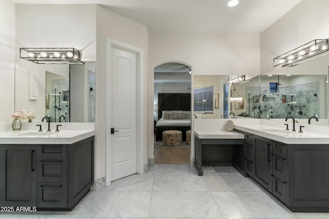 bathroom with walk in shower, vanity, and ceiling fan