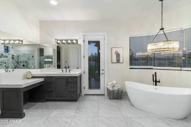 bathroom with vanity, independent shower and bath, and a notable chandelier